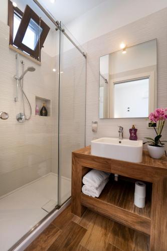 a bathroom with a sink and a shower at Hotel Antica Cascina Del Golfo in Scopello
