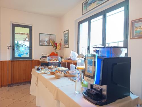 a room with a table with a computer on it at Hotel BB Villa Orchidea in Stresa