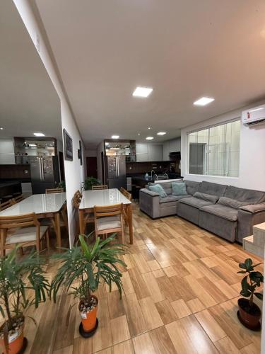 a living room with a couch and a table at Casa completa e confortável, 15 minutos dá praia in Maceió