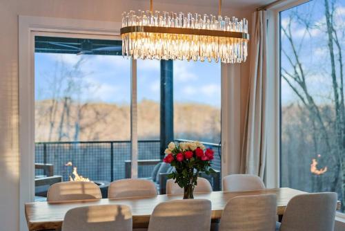 a dining room with a table with a vase of flowers at Adamina Canyon Luxurious, Canyon View 5BR, 3BTH 1 in Rockbridge