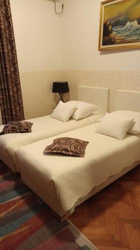 two beds sitting next to each other in a room at Guesthouse Vrlic in Split