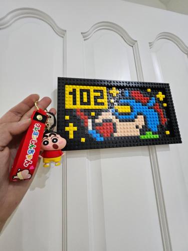 a person holding a lego puzzle hanging on a door at 舞浪海景旅店 in Xiaoliuqiu