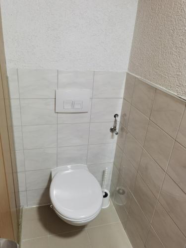 a bathroom with a white toilet in a stall at Ferienwohnung am Backhaus 1 in Ahnatal