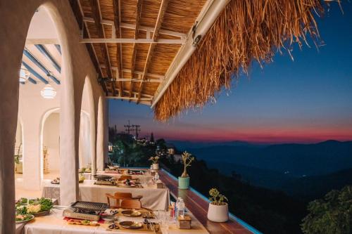 a restaurant with a view of the mountains at Nontawa Villa Doichang in Ban Huai Khai