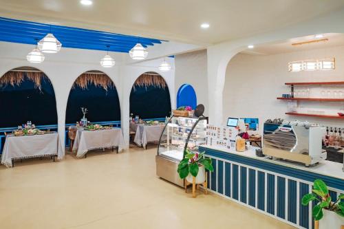 a store with tables and chairs in a room at Nontawa Villa Doichang in Ban Huai Khai