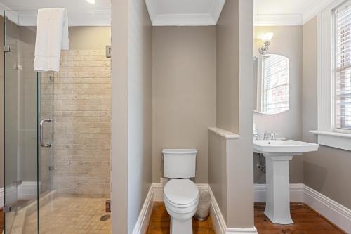 a bathroom with a toilet and a sink at Walk To Bars Shopping River Street!-3 in Savannah