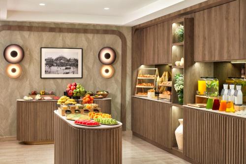 a bakery with a variety of fruits and pastries on display at NH Geneva Airport Hotel in Geneva
