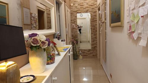 a hallway with a vase of flowers on a counter at Guesthouse Vrlic in Split
