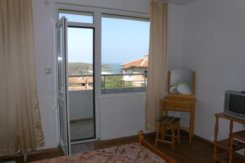 a room with a sliding glass door with a balcony at Prestige in Sinemorets