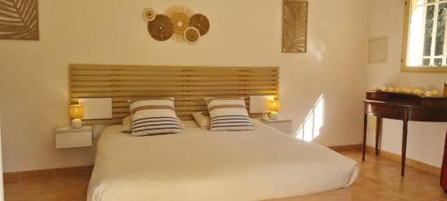 a bedroom with a large white bed with striped pillows at Prea Gianca in Bonifacio