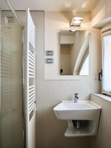 a bathroom with a sink and a mirror at Avveduti Boutique Apartment in Fano