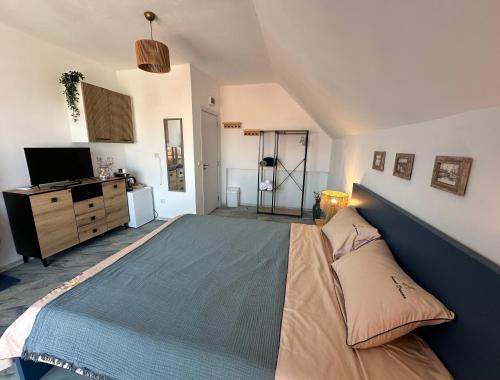 a bedroom with a large bed and a television at SummerBlue - Синьо лято in Lozenets