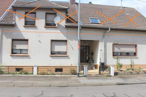 a house with orange crosses on the side of it at Fewo in Weierbach bei Idar-Oberstein in Idar-Oberstein