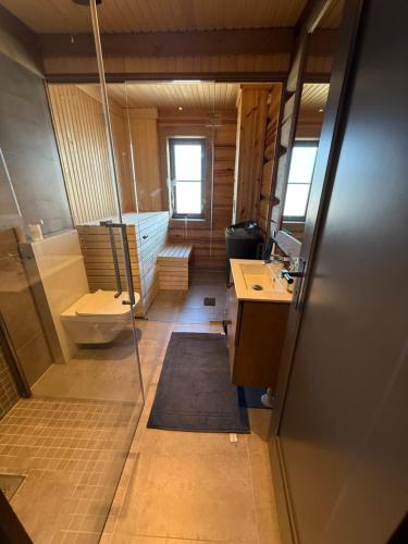 a bathroom with a tub and a toilet and a sink at Nordic Gateway Logde in Hafjell