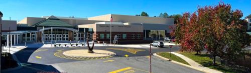 a large building with a parking lot in front of it at Humble Family Escape with Ping-Pong, Near Downtown Hickory in Hickory