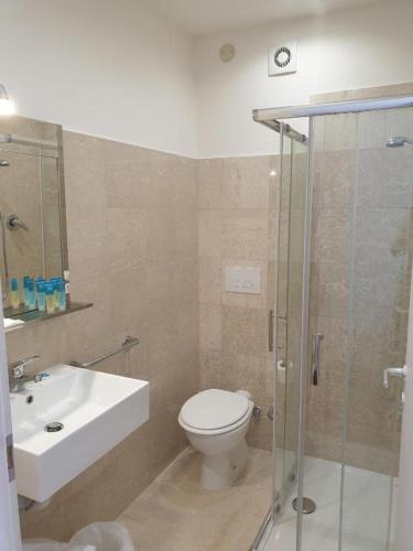 a bathroom with a toilet and a sink and a shower at Hotel Morandi in Sanremo