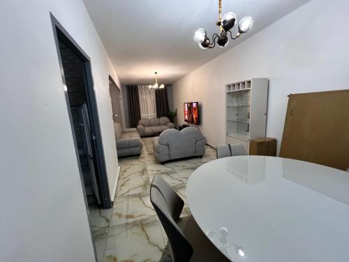 a living room with a white table and chairs at Sweet House Residence in Douala