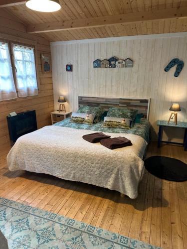 a bedroom with a bed with two pillows on it at Maison de Lege in Lège-Cap-Ferret
