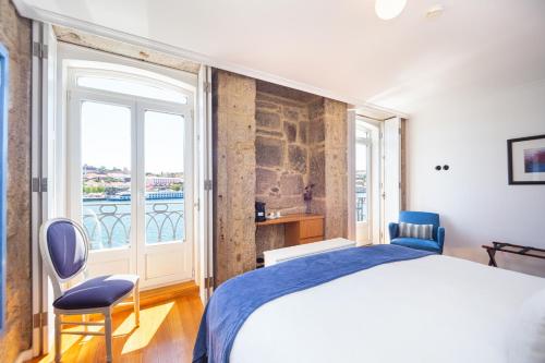 a bedroom with a bed and a large window at 1872 River House by Olivia in Porto