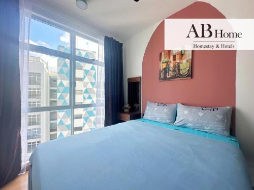 a bedroom with a blue bed and a large window at ABHOME "HOLIDAY SUITE" #Midas Seri Alam #High Floor #Mall #JB in Masai