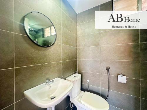 a bathroom with a sink and a mirror and a toilet at ABHOME "HOLIDAY SUITE" #Midas Seri Alam #High Floor #Mall #JB in Masai