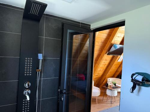 a bathroom with a shower with a glass door at Thethi Villas in Theth