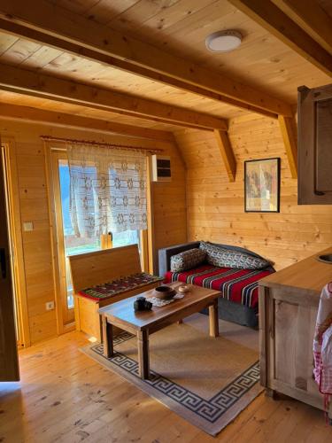 a living room with a couch and a table at Ethno house Dušanovi stupovi in Ćetkovići