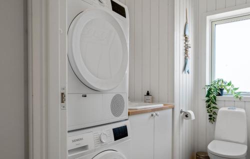 a bathroom with a toilet and a microwave at Lovely Home In Stege With Sauna in Stege