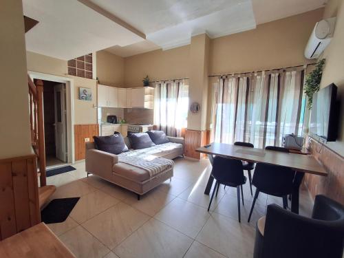 a living room with a couch and a table at Delight Apartments in Golem