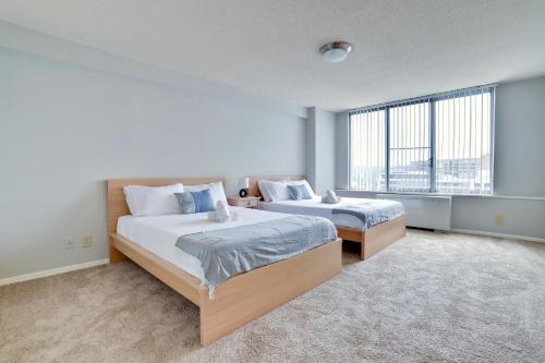 a bedroom with two beds and a large window at Family-Sized 3BR Retreat Minutes from Reagan National in Arlington