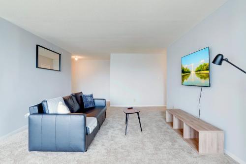 a living room with a couch and a table at Family-Sized 3BR Retreat Minutes from Reagan National in Arlington