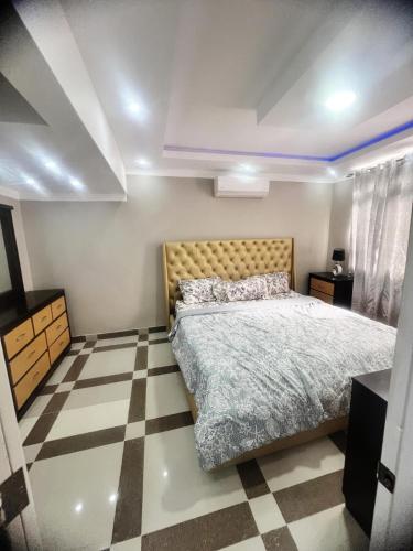 a bedroom with a bed and a checkered floor at Escape to paradise! in Santiago de los Caballeros