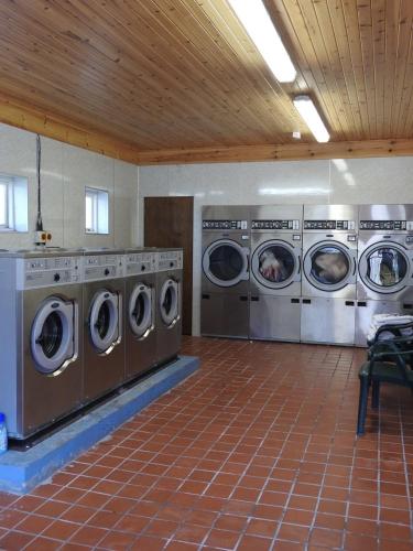 a row of washing machines in a laundry room at Faskally Woods Holiday Park in Pitlochry