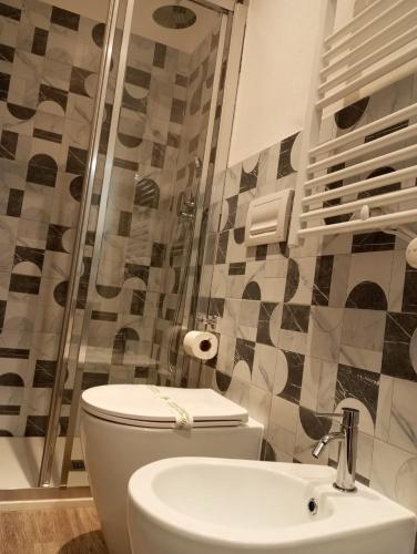 a bathroom with a toilet and a sink and a shower at Hotel Acquario in Genova