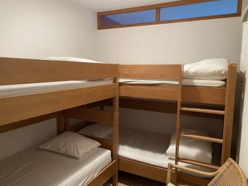 a room with three bunk beds and a window at Vue Mer, Golfe et Dunes- Résidence Dunes du Golfe in Wimereux