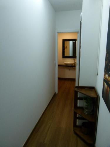 a room with a white wall and a wooden floor at Boa Ventura Home in Porto