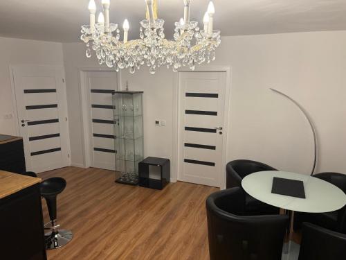 a living room with a chandelier and a table and chairs at Vienna Luxury Dream Home in Vienna