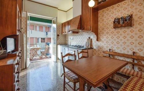 a kitchen with a wooden table and a dining room at Gorgeous Apartment In Recco With Wifi in Recco