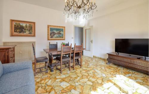 a living room with a dining table and a flat screen tv at Gorgeous Apartment In Recco With Wifi in Recco