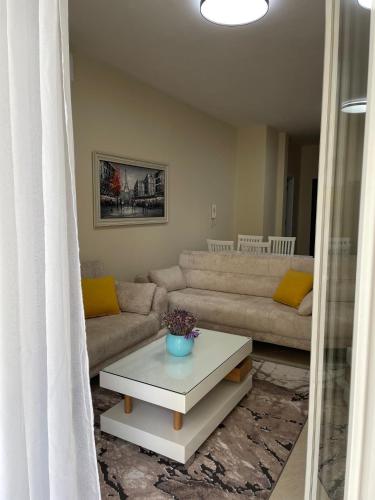 a living room with a couch and a table at Albanian Bliss in Tirana