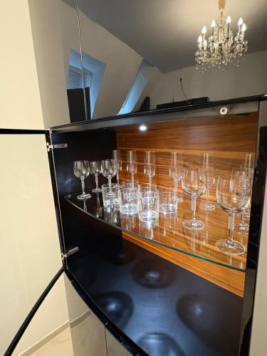 a bunch of wine glasses sitting on a shelf at Vienna Luxury Dream Home in Vienna