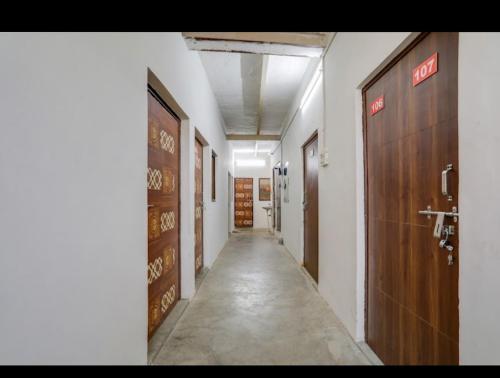a hallway with two doors and a long corridor at Hotel Nandani Palace in Mathura