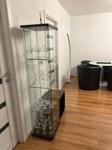 a glass display case with wine glasses in a room at Vienna Luxury Dream Home in Vienna