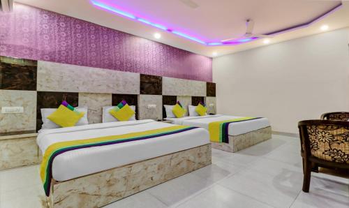 two beds in a room with a purple wall at Hotel Royal Residency Near ISBT-Max Hospital Mohali Chandigarh in Mohali