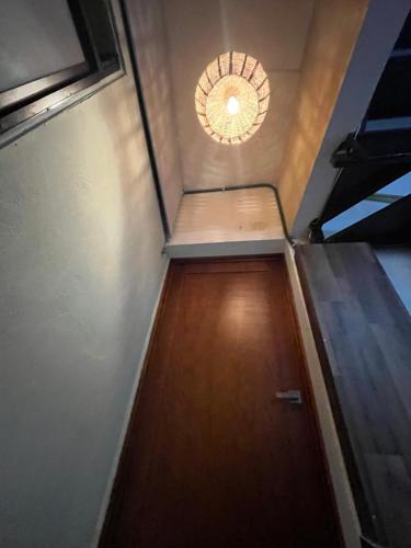 a hallway with a door and a light on the ceiling at San Fernando Hostal in Oaxaca City