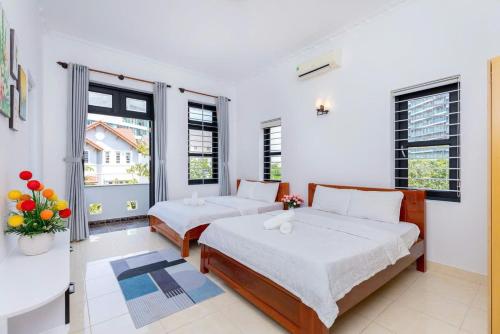 a bedroom with two beds and a window at Kegotel Villa Bãi Sau ngay Tháp Tam Thắng in Vung Tau
