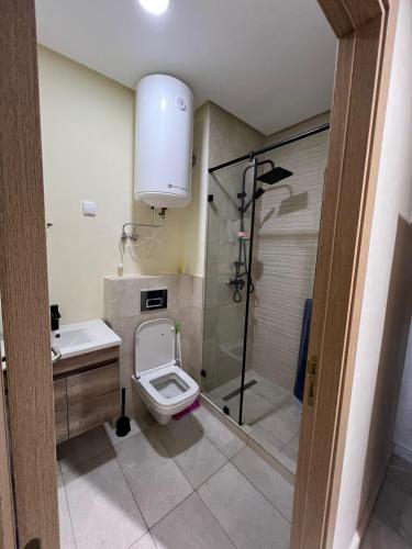 a bathroom with a toilet and a shower at Ocean park zenata in Aïn Harrouda