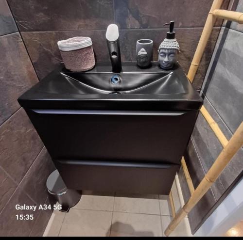 a black sink in a bathroom in at GITE 2 personnes avec piscine in Le Bosc