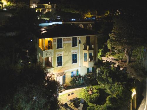 an aerial view of a large white house at night at Villa Margherita in Levanto