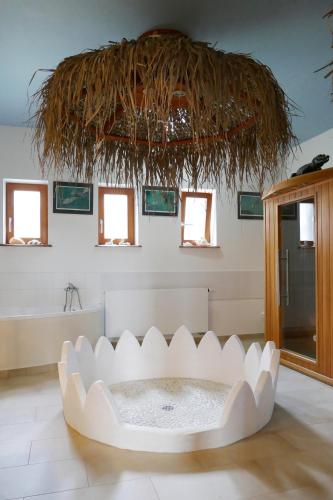 a bathroom with a large white tub in a room at Chalupa Pohoda in Velké Karlovice